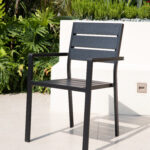 Black modern outdoor armchair with aluminum frame and wood-look slats