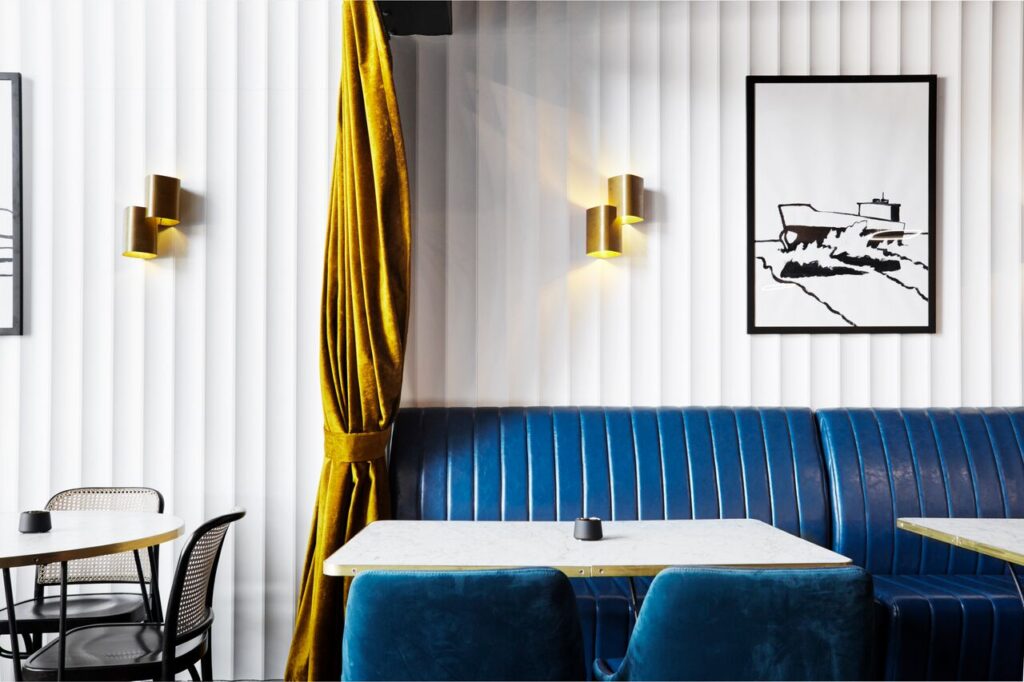 Modern cafe interior with blue upholstered booth seating