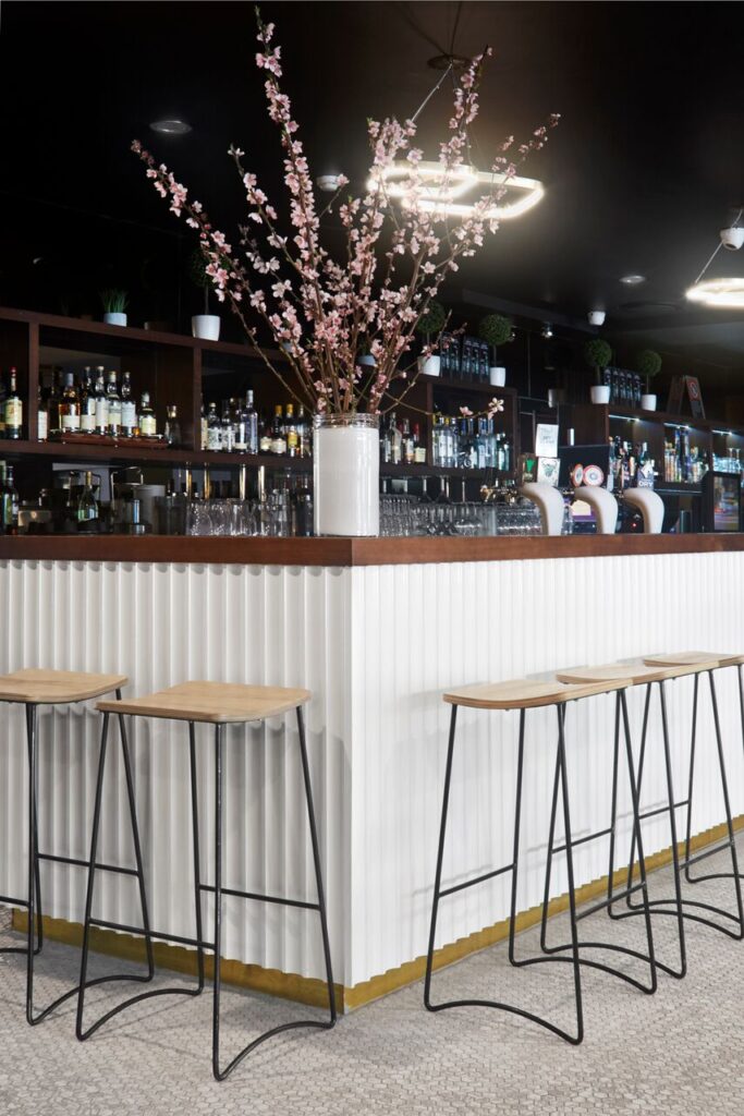 Modern bar interior with white ribbed counter