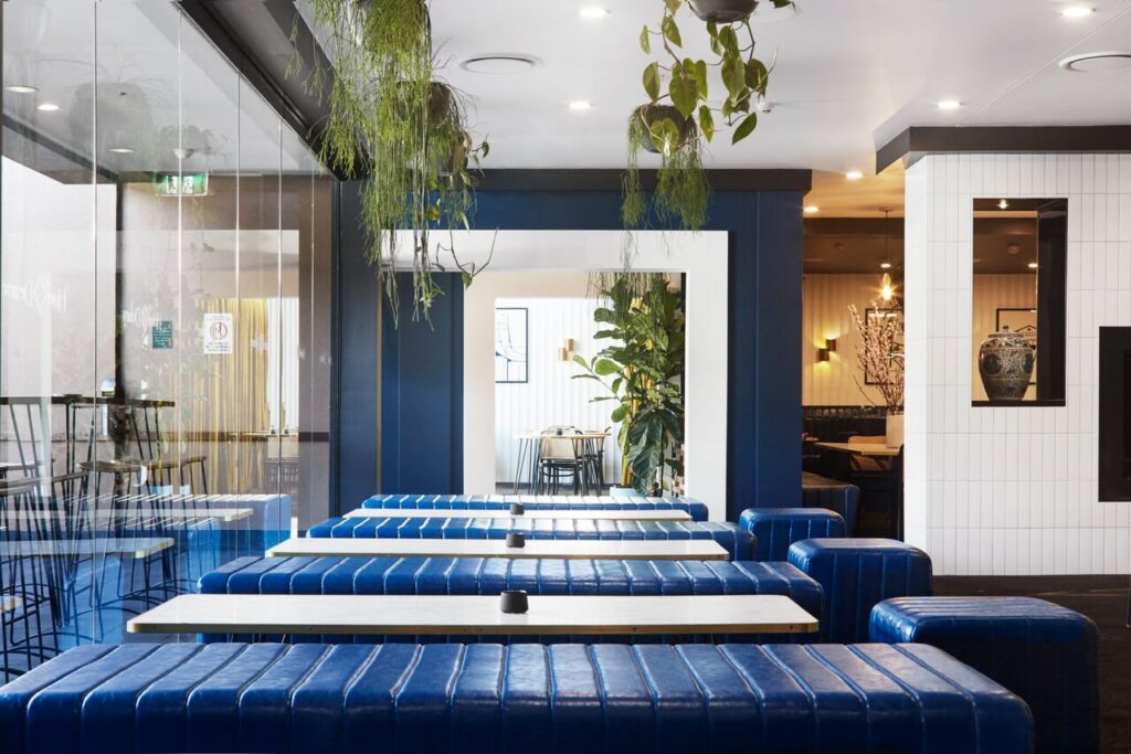 Modern restaurant interior with blue upholstered booth seating
