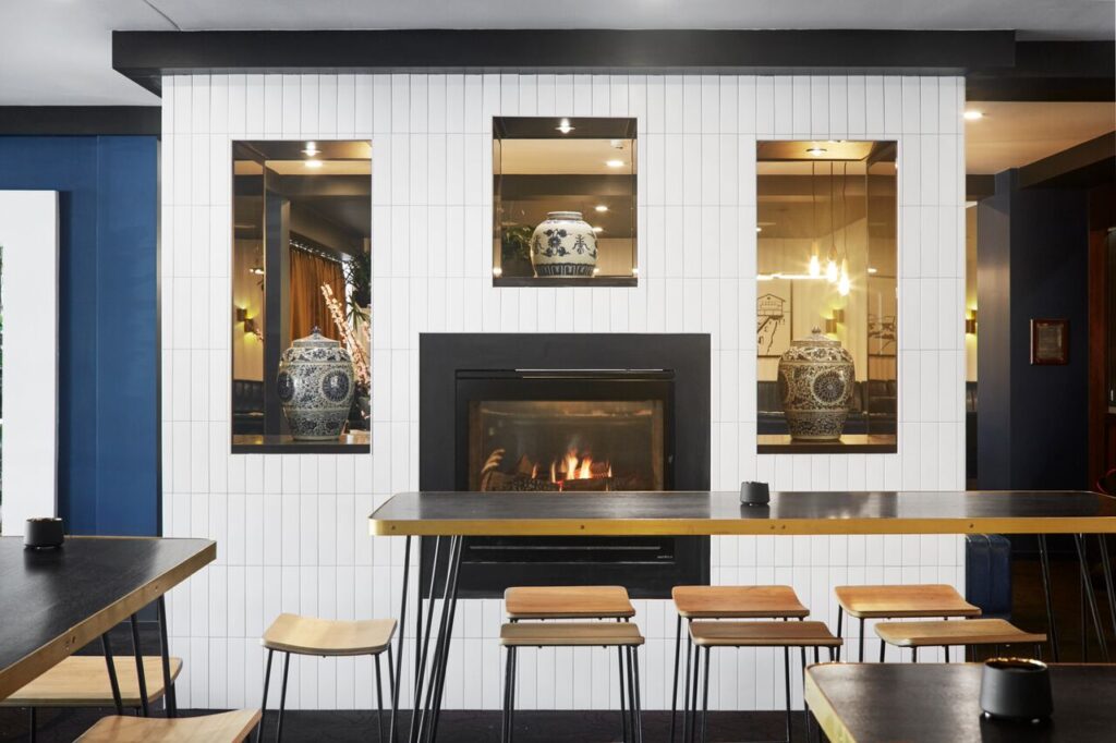 Contemporary restaurant interior featuring a built-in fireplace