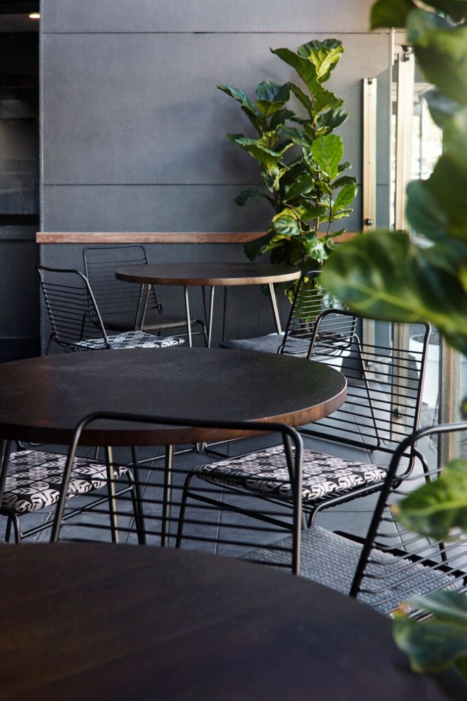 Small modern seating area with round dark tables