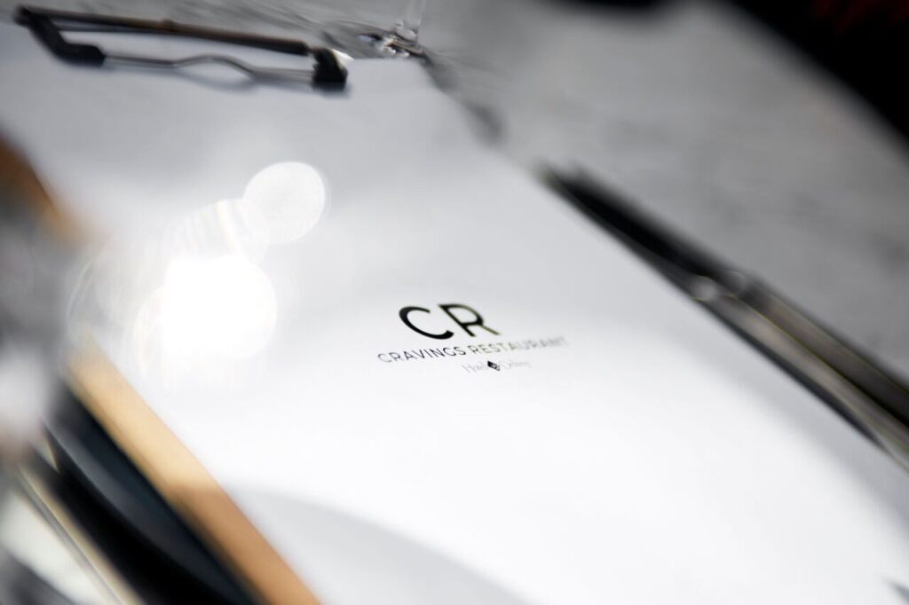 Close-up of a restaurant menu with the CR Cravings Restaurant logo