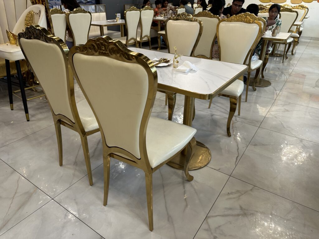 Elegant restaurant interior with white-and-gold chairs
