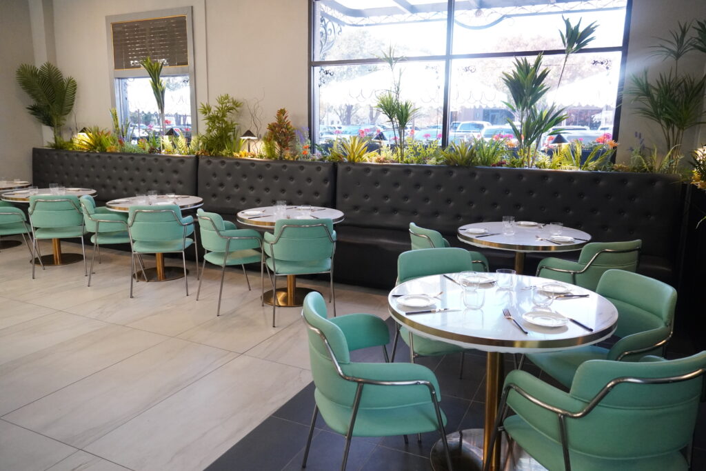 Bright restaurant seating area with mint-green chairs