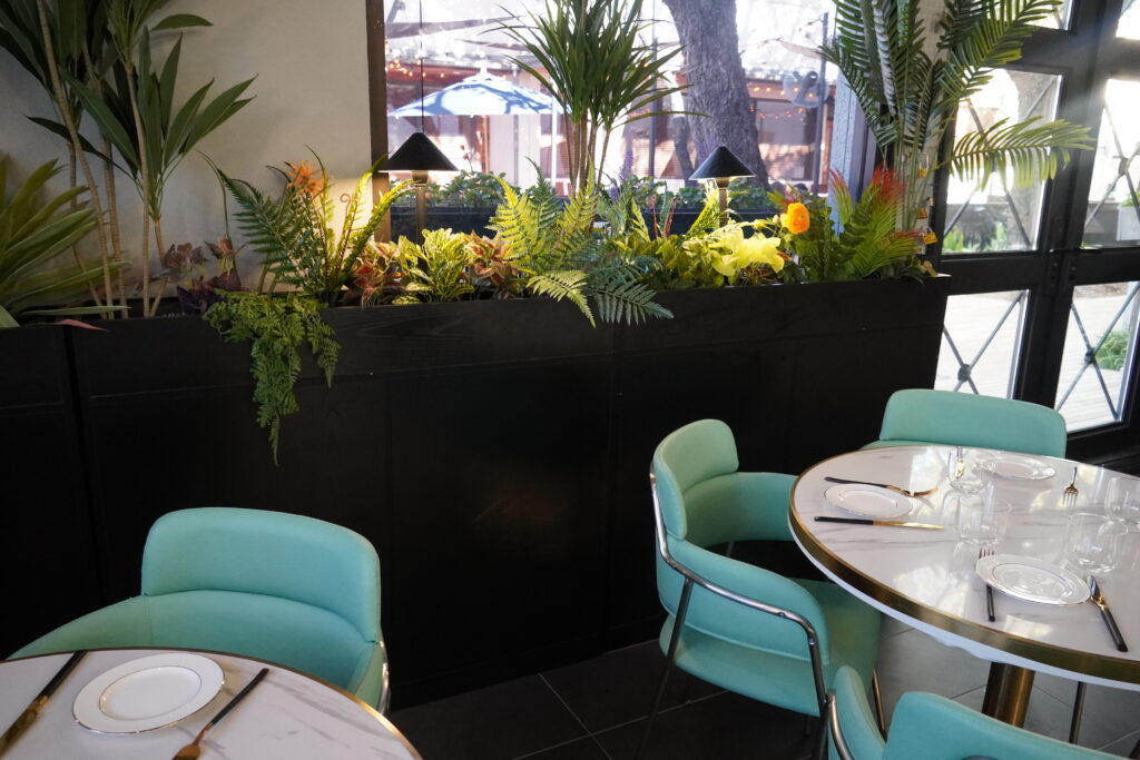 Bright, modern restaurant interior with lush greenery
