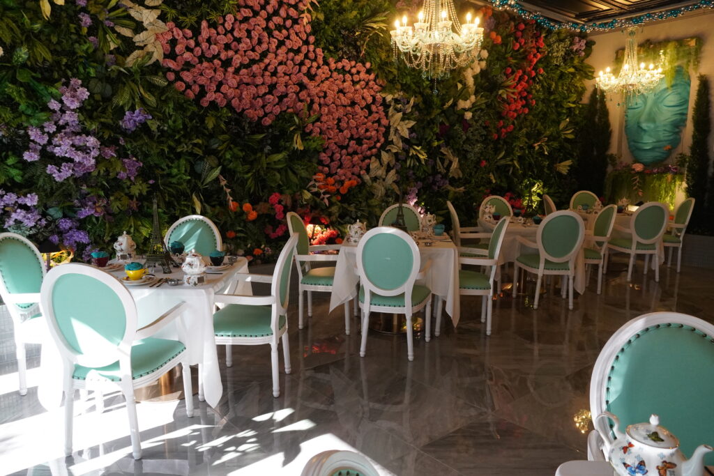 Elegant tea room with mint-green chairs and white tables set